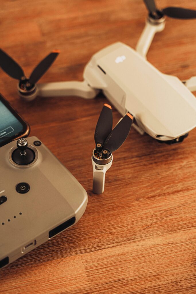 Close-up of a drone and remote controller on a wooden surface, modern technology.