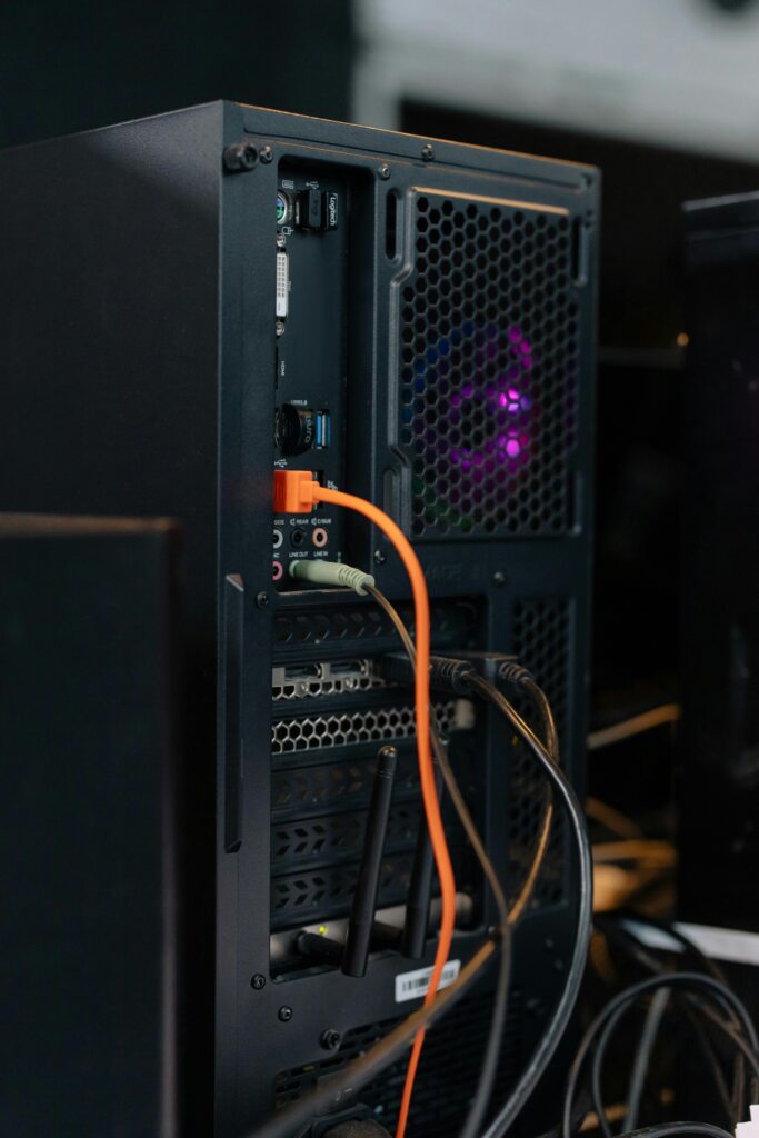 Close-up of a desktop computer tower with connected cables and internal lighting.