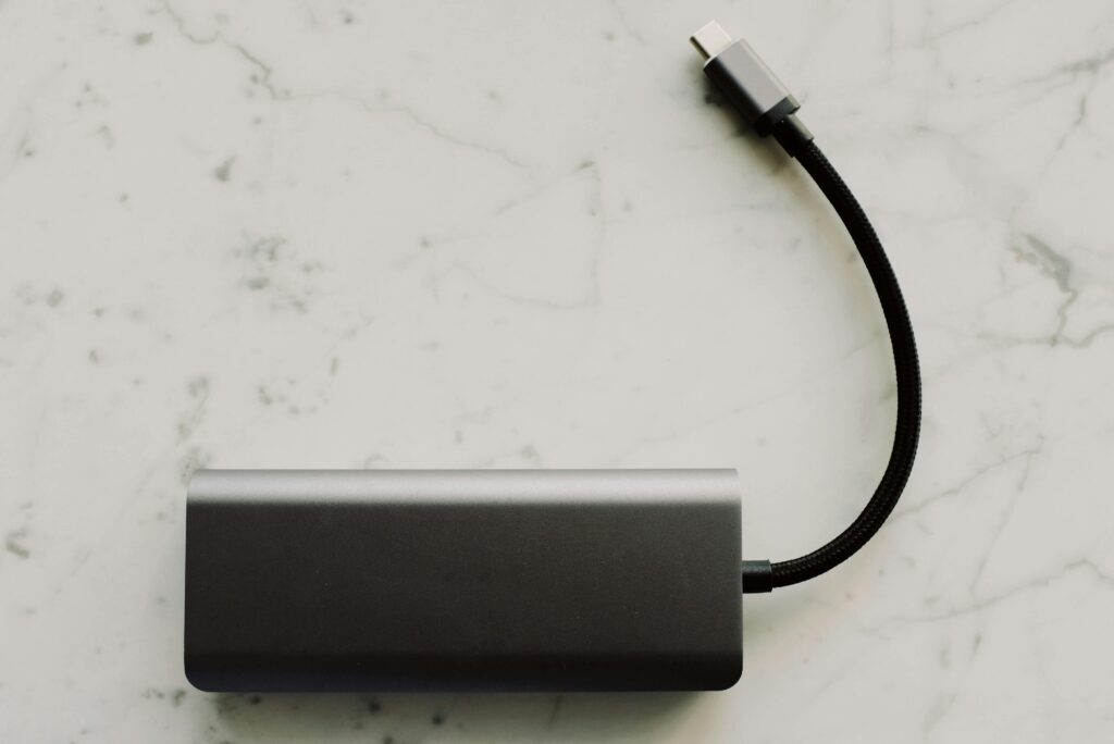 Sleek power bank with USB-C cable on a marble surface, ideal for travel tech needs.