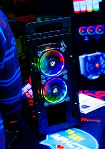 Close-up of a modern PC case featuring vibrant RGB LED fans, showcasing futuristic technology.