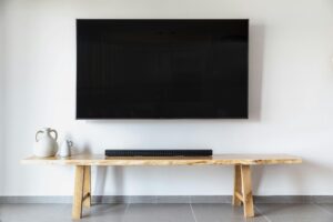 Stylish minimalist living room featuring a wall-mounted flat screen TV and wooden console.